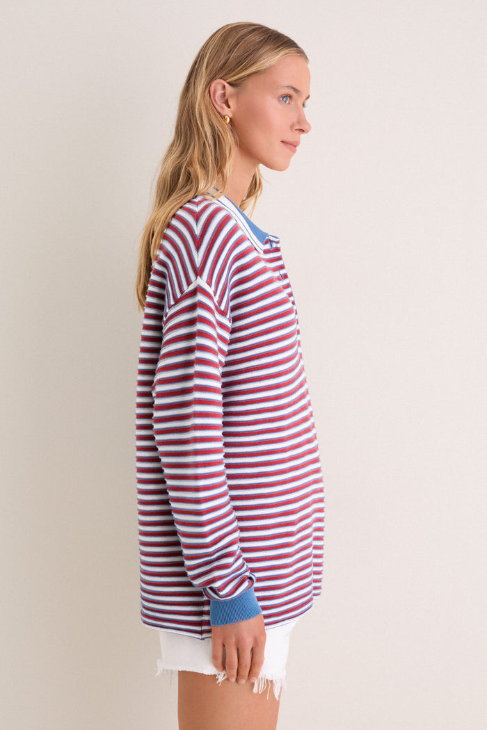 Young woman in profile wearing the classic All-Star Stripe Clark Sweater with narrow stripes, embodying an effortless, high-end style, perfect for fun, confident outings.