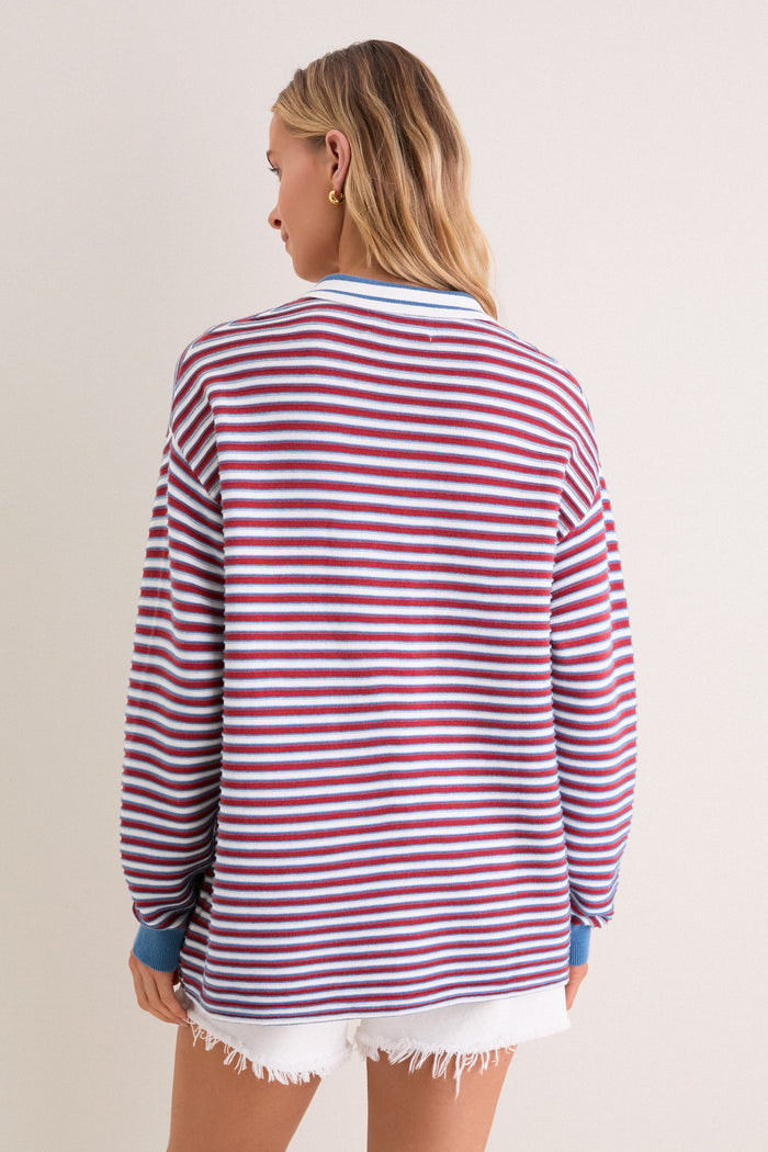 Back view of a person in the All-Star Stripe Clark Sweater, a classic, effortlessly cool top with red and white stripes, exuding high-end, fun style.