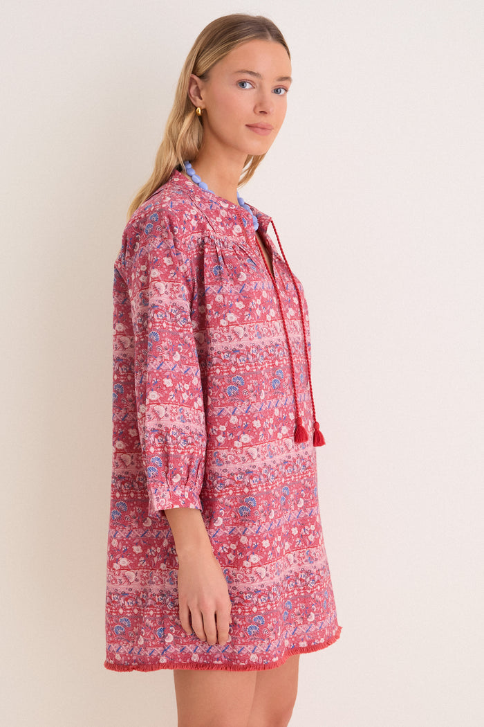 Young person in profile wearing the Americana Batik Stripe Bondi Coverup—classic, effortless boho-chic with tassel ties and fringed hem—perfect for fun, high-end outings.