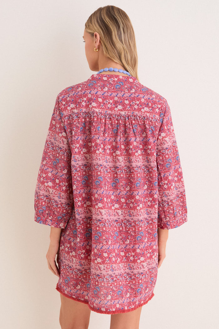 Classic back view of a woman in an effortless, high-end Americana Batik Stripe Bondi Coverup, featuring floral-geometric print and a chunky necklace. Fun and chic style.