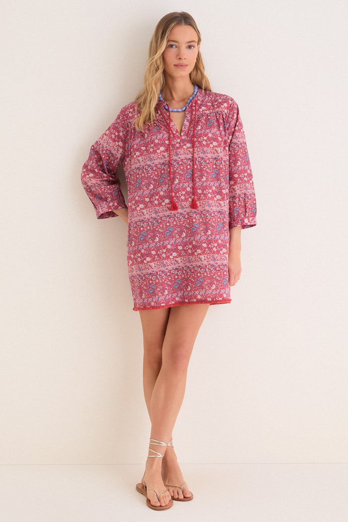 Young woman in a classic, effortless Bondi Coverup with boho print, tassel neckties, and three-quarter sleeves. Perfect for fun, high-end style at Tuckernuck.