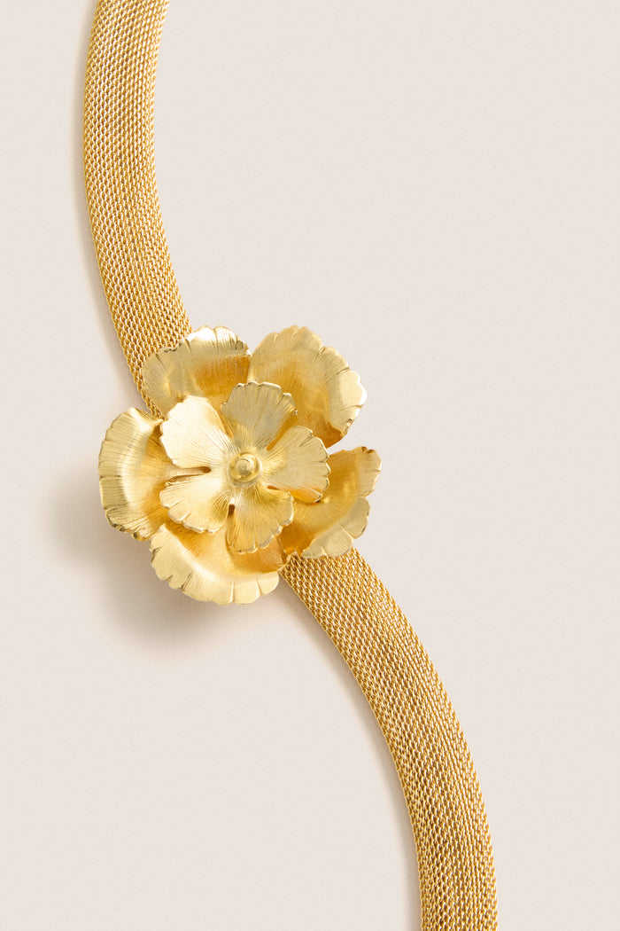 Antique Gold Eden Mesh Choker featuring a classic, sculpted floral pendant on a high-end gold-tone mesh band, reflecting effortless elegance and fun sophistication.