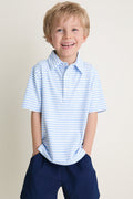 Young boy in classic, effortless Bachelor's Blue and White Le Club Polo, smiling with hands in navy shorts' pockets. Perfect for fun, high-end everyday wear.