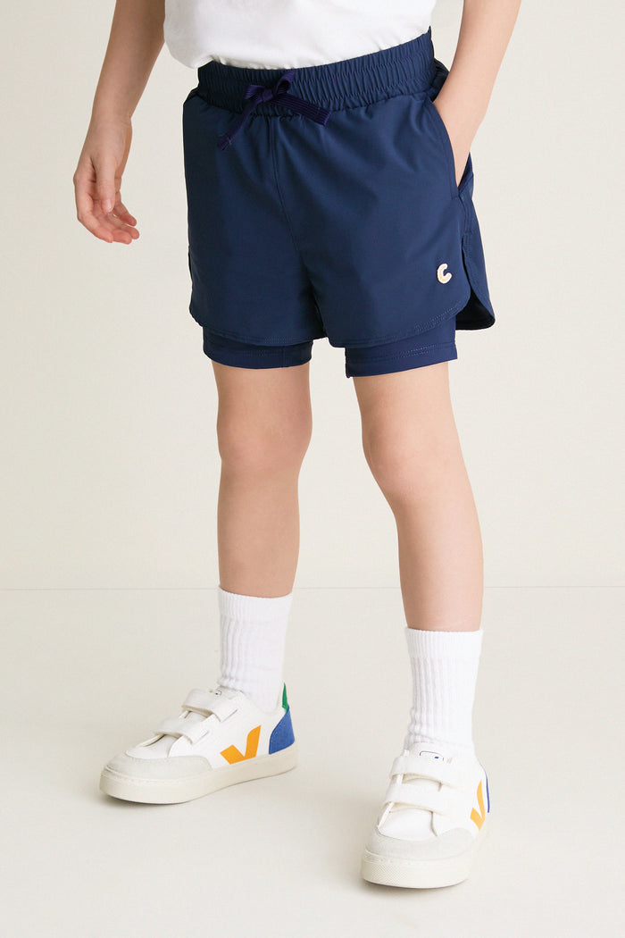 Before Sunrise Blue Cardio Short: classic athletic shorts with elastic drawstring waist, visible liners, and pockets. Paired with white socks and sneakers for an effortless, fun, high-end look.