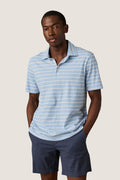 Man wearing the classic Bermuda Sail Stripe Sunwashed Tee Shirt Polo, showcasing an effortless, high-end look with a fun twist, embodying Tuckernuck’s cool and confident style.