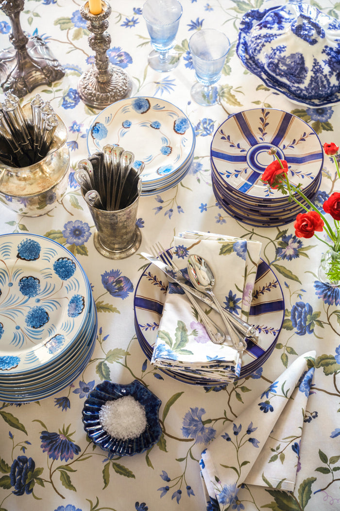 Overhead view of a classic, high-end tabletop showcasing the Blue and Lavender Blossom Printed Napkins Set of 4, adding effortless elegance and fun to the vintage-inspired setting.