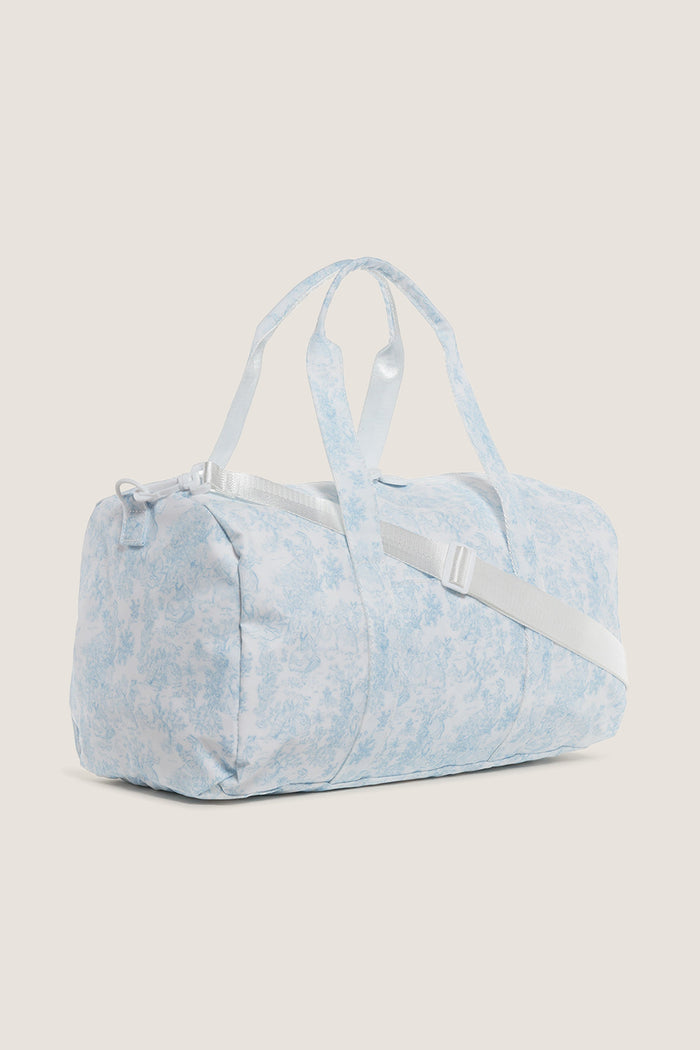 Classic Blue Bunny Toile Weekender Duffel Bag with detachable strap, white zipper closure, and interior mesh pocket. Effortless, fun design perfect for high-end, practical travel.