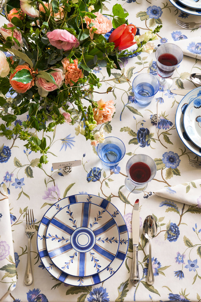 Blue Stripe Dinner Plate with classic stripe-and-vine design, set on elegant table with floral centerpiece and stemmed glasses, embodying effortless, high-end dining for fun occasions.