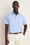 Man wearing Bluebird Grace Performance Mesh Polo, showcasing its classic, effortless style with a spread collar and button placket, perfect for high-end, fun occasions.