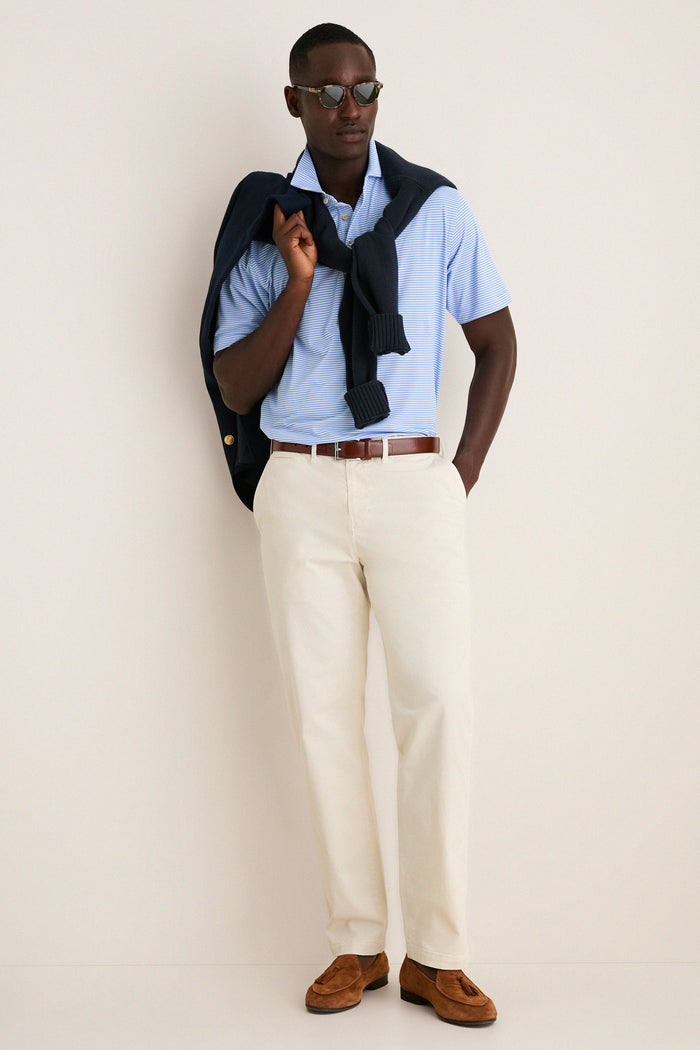 Model wearing the Bluebird Grace Performance Mesh Polo, a classic, effortless piece with a subtle stripe pattern, ideal for a high-end, fun smart-casual look.