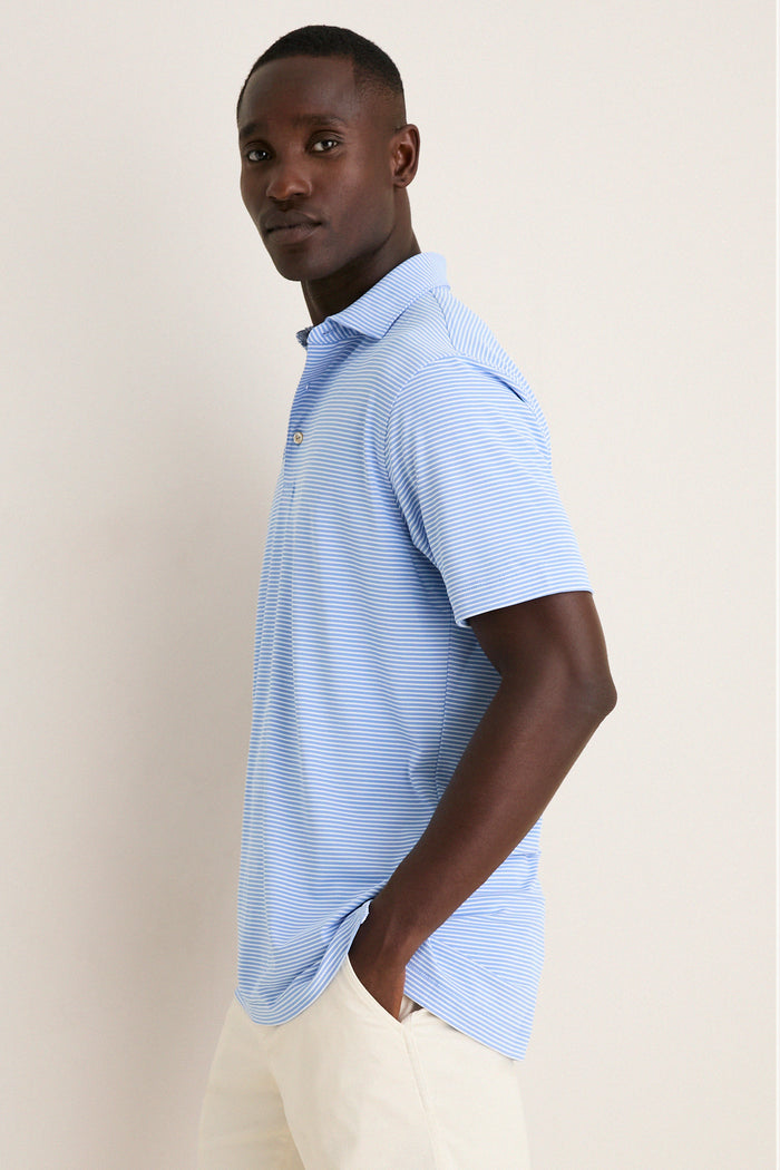 Man in profile wearing Bluebird Grace Performance Mesh Polo, showcasing its classic, effortless style and high-end fabric, exemplifying fun, versatile fashion for any setting.