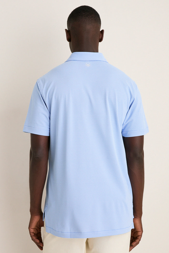 Person in a light-blue, short-sleeve Bluebird Grace Performance Mesh Polo with subtle white stripes, embodying a classic, effortless, high-end style suitable for fun and versatile occasions.