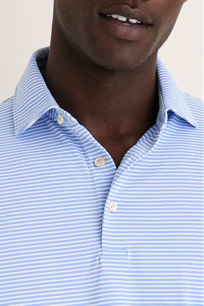 Man wearing the Bluebird Grace Performance Mesh Polo, showcasing its classic, high-end design with a buttoned collar and effortless, fun style for versatile, everyday wear.