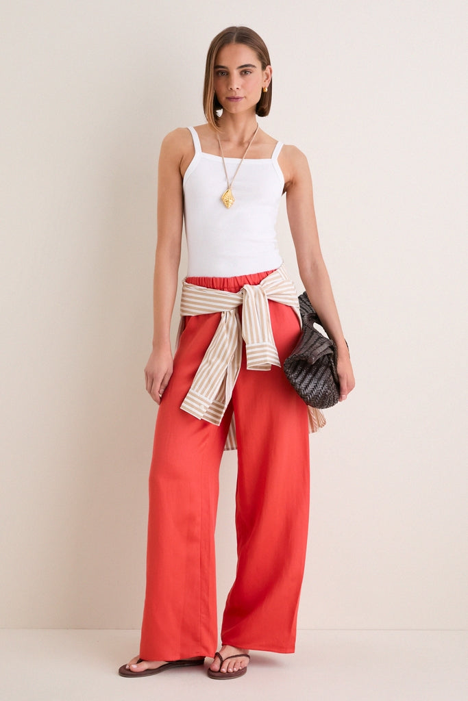Woman showcasing Bourbon Lily Braid Suede Flip Flops with braided straps, embodying classic and effortless style. Perfect for fun, high-end, everyday wear.
