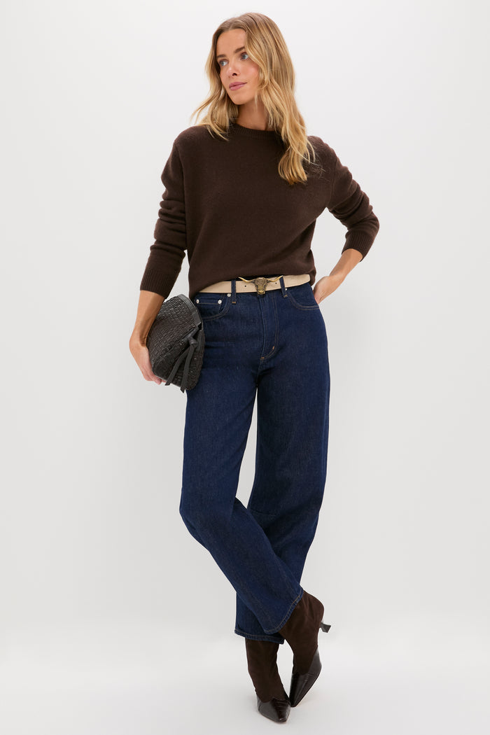 Woman in classic high-waisted jeans and sweater showcasing the Brass Lansing Longhorn Buckle, adding an effortless, high-end touch with a fun longhorn motif.
