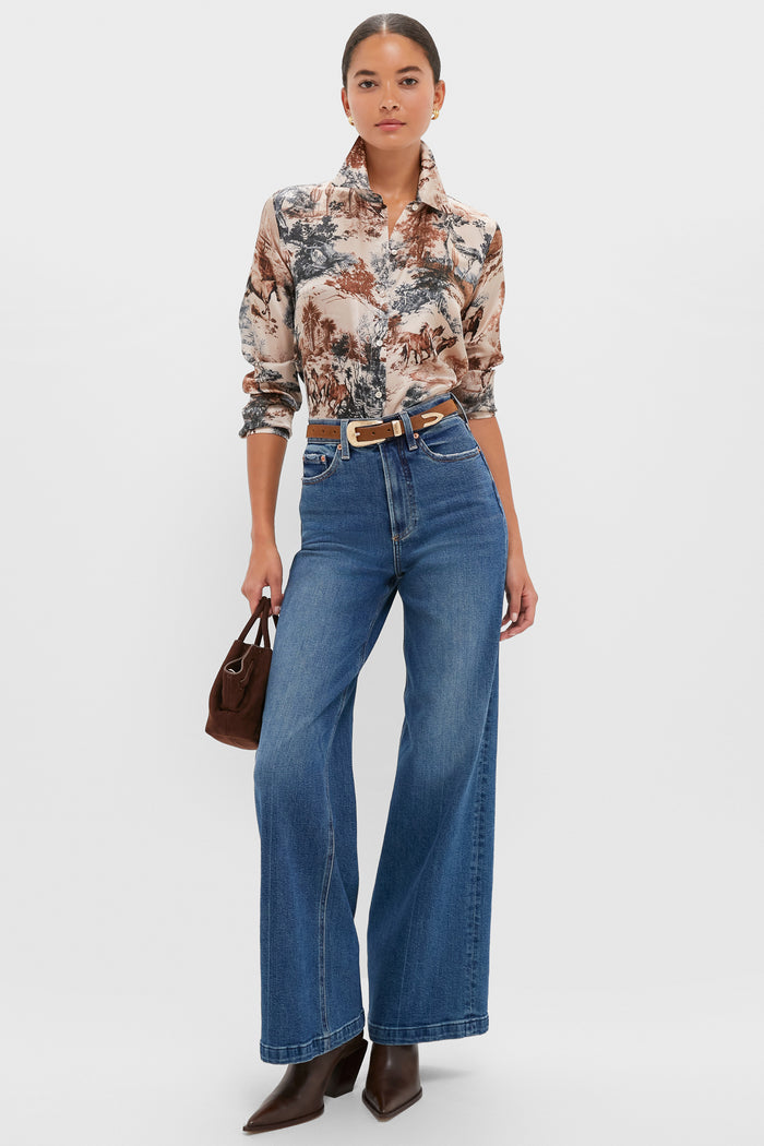 Model showcases the Brown Suede and Gold Phoenix Belt, pairing classic equestrian-style shirt with effortless high-waisted jeans and fun, high-end accessories for a chic, confident look.