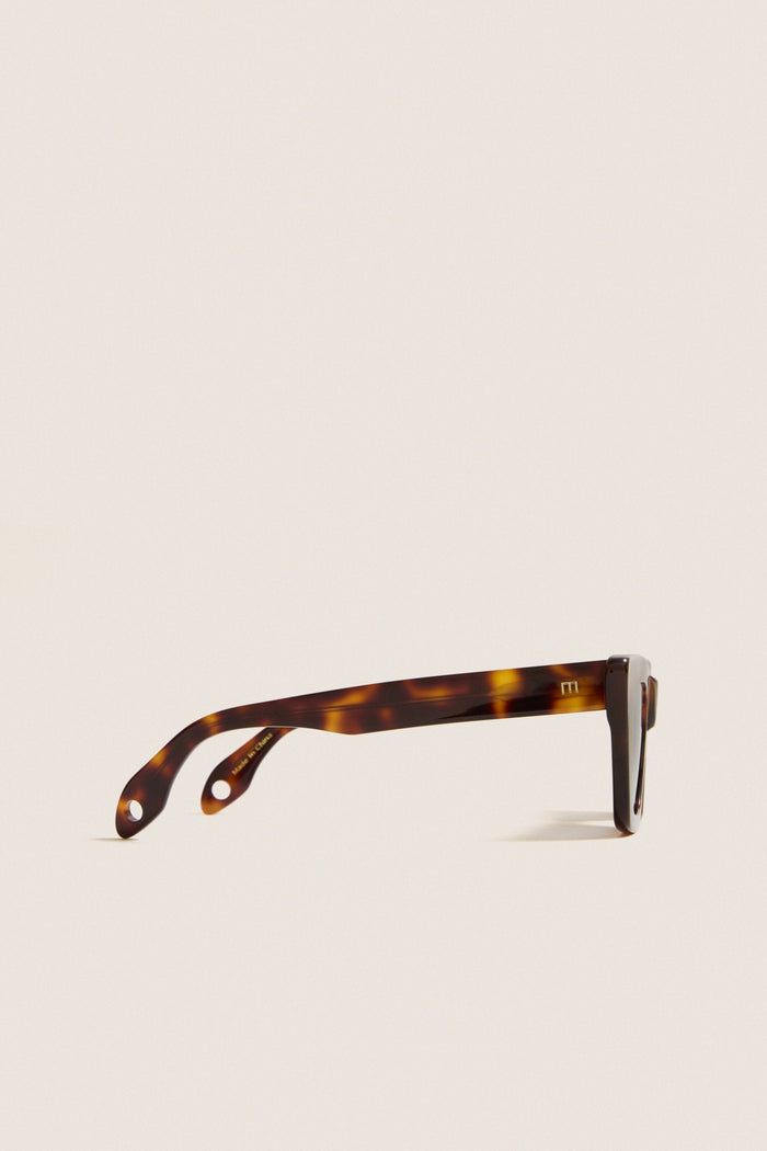Classic Brown Tortoise Dark Blue Lens Lori Sunglasses in cat-eye design, showcasing a side-profile with branded logo, offering effortless style and high-end flair.