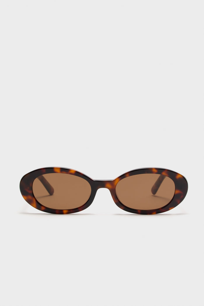Brown Tortoise Lyric Leigh Sunglasses, featuring classic, effortless oval frames with UV protection, embodying high-end style and fun sophistication.