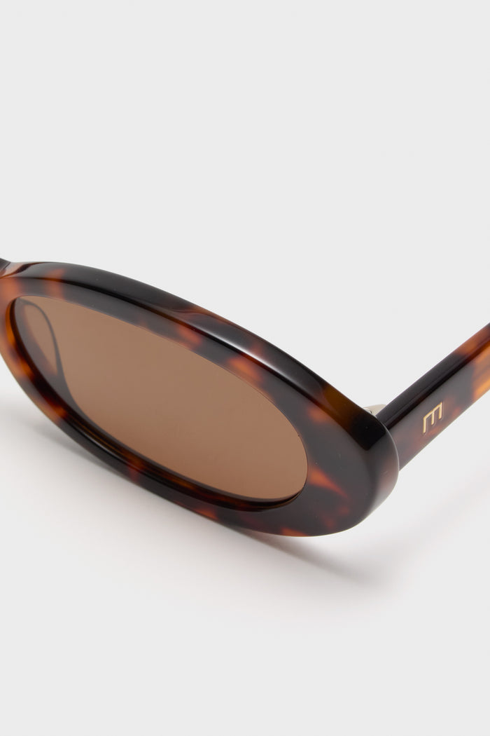 Brown Tortoise Lyric Leigh Sunglasses feature classic oval frames with a glossy tortoiseshell pattern and brown lenses, blending effortless fun with high-end style.
