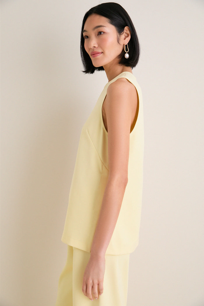 Model in profile wearing the classic, effortless Butter Maxime Top, featuring a crewneck and sleeveless design, paired with matching pants for a high-end, fun look.