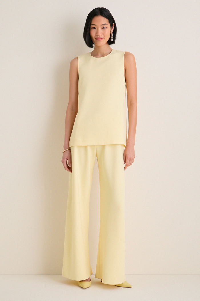 Model in a classic Butter Maxime Top, sleeveless with a crew neckline, styled with matching wide-leg trousers and pointed heels for an effortless, high-end look.