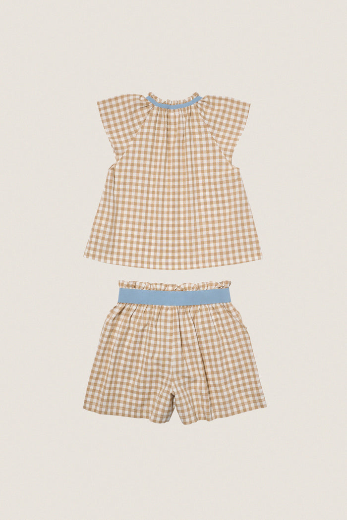 Camel Check Cecil Short Set, a classic gingham two-piece with effortless style. Features a ruffled blouse and elastic shorts, perfect for fun, high-end summer outings.