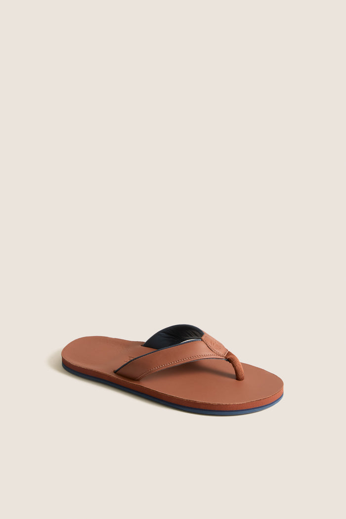 Cask Clipper Waterproof Leather Sandal: A classic, high-end men’s flip-flop with brown leather footbed and straps, featuring waterproof design for effortless, fun coastal adventures.