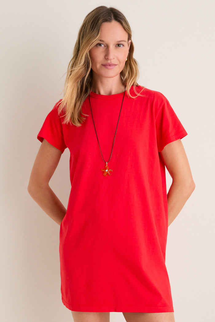 Cerise Margo Mini Dress: A classic, effortless T-shirt style in bold red with a fun, high-end silhouette, worn with a starfish pendant necklace.