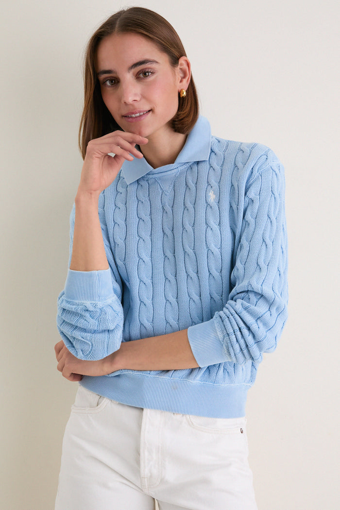 Young woman models the Chambray Blue Cotton Knit Polo, a classic, effortlessly layered sweater with a collared shirt, embodying Tuckernuck's fun and high-end style.