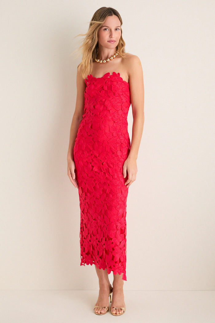 Woman models the Cherry Red Philomena Midi Dress, featuring a classic strapless design and raised floral-lace pattern, paired with gold accessories for an effortless, high-end look.