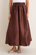 Classic and effortless, the Chestnut Taffeta Cynthia Bubble Skirt features a fun, high-end bubble hem and elastic waistband, styled with woven sandals for a chic look.