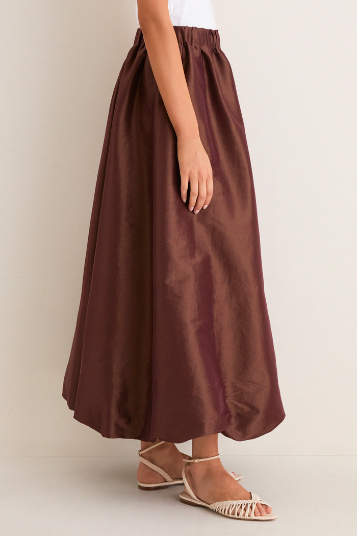 Classic and effortless, the Chestnut Taffeta Cynthia Bubble Skirt features a fun bubble hem and elastic waistband, paired with high-end beige braided-strap sandals.