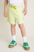 Child mannequin in Citron Zest Cardio Short, blending classic athletic style with effortless fun. Paired with white socks and sneakers, perfect for active, high-end comfort.