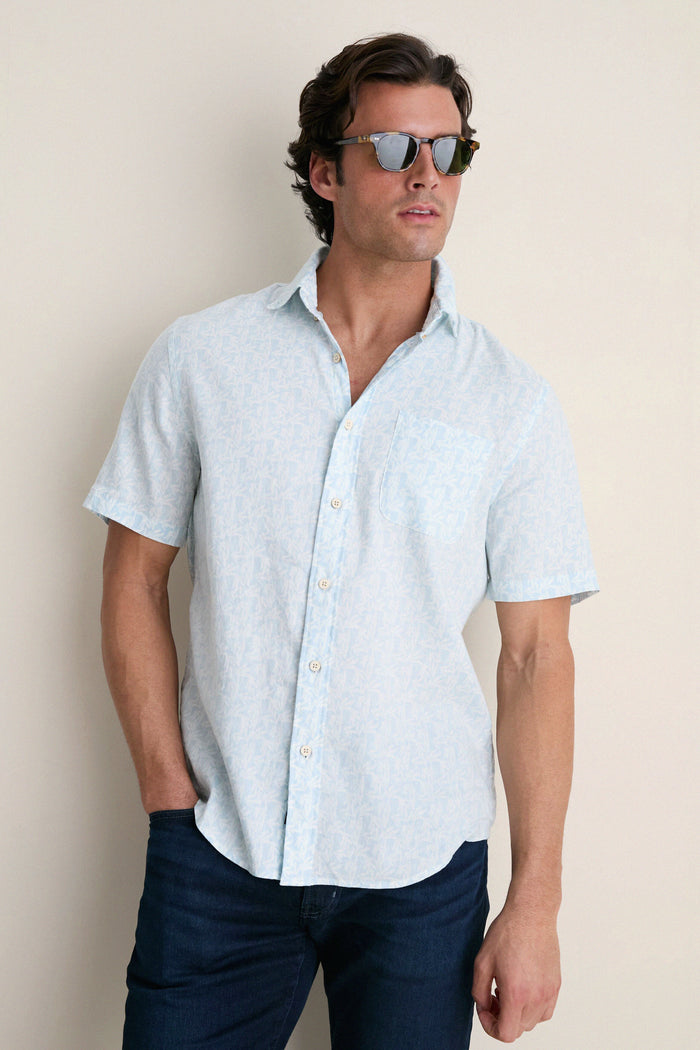 Young man in a classic Clear Sky Leaf Breeze Shirt with tortoiseshell sunglasses, showcasing an effortless, high-end summer style perfect for fun, relaxed outings.