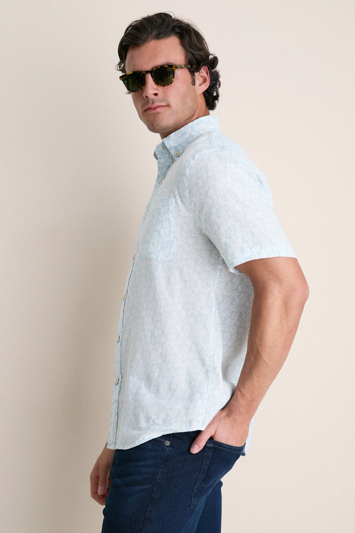 Young man in a classic, effortless Clear Sky Leaf Breeze Shirt, showcasing a relaxed fit and subtle leaf print, embodying high-end, fun summer style.