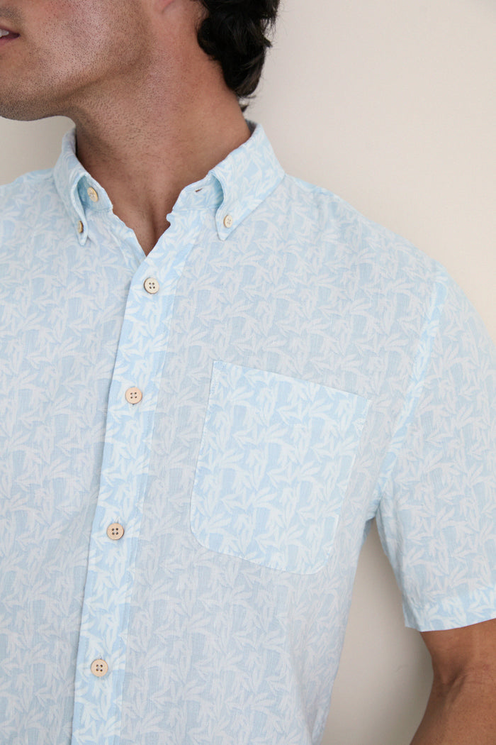 Clear Sky Leaf Breeze Shirt: Effortless, classic short-sleeve shirt with a subtle leaf print, perfect for high-end, fun summer days. Features button placket and chest pocket.