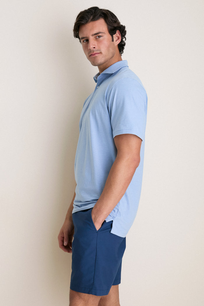 Young man models the Cloudy Blue Ryles Crown Flex Cotton Polo, showcasing its classic cutaway collar and effortless, high-end style for fun, casual wear.