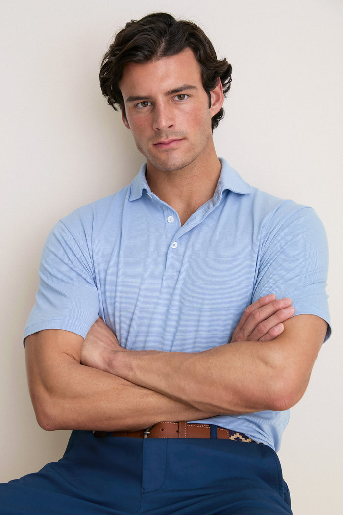 Young man in a classic, effortless Cloudy Blue Ryles Crown Flex Cotton Polo, showcasing its high-end, fun design and luxurious craftsmanship.