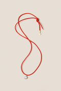 Coral Red Necklace Cord with Blue Bezel Charm, featuring a classic red lariat design with gold accents and a star motif, for effortless, high-end, fun styling.
