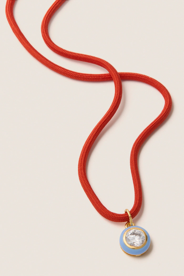 Coral Red Necklace Cord with Blue Bezel Charm features a classic red braid and a high-end blue pendant, offering effortless style for fun, versatile wear.
