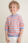 Young boy wearing the classic Coral Stripe Bromo Cotton Jumper, featuring intarsia stripes, ribbed trims, and wooden buttons, embodying effortless, high-end style.