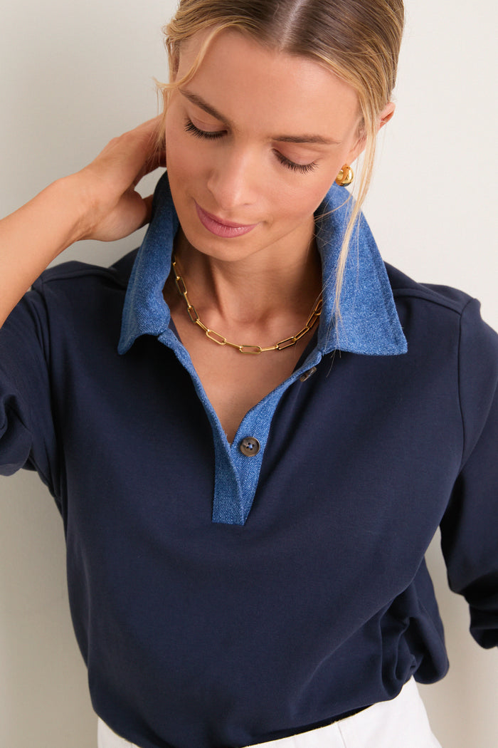 Young woman wearing the Denim Collar Carlyn Long Sleeve Polo, showcasing its classic yet high-end design with a playful denim collar and effortless, fun styling.