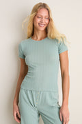 Young woman in Eucalyptus Slim Fit Pointelle Tee, showcasing classic, effortless style with scalloped edges and eyelet details, perfect for a fun, high-end look.