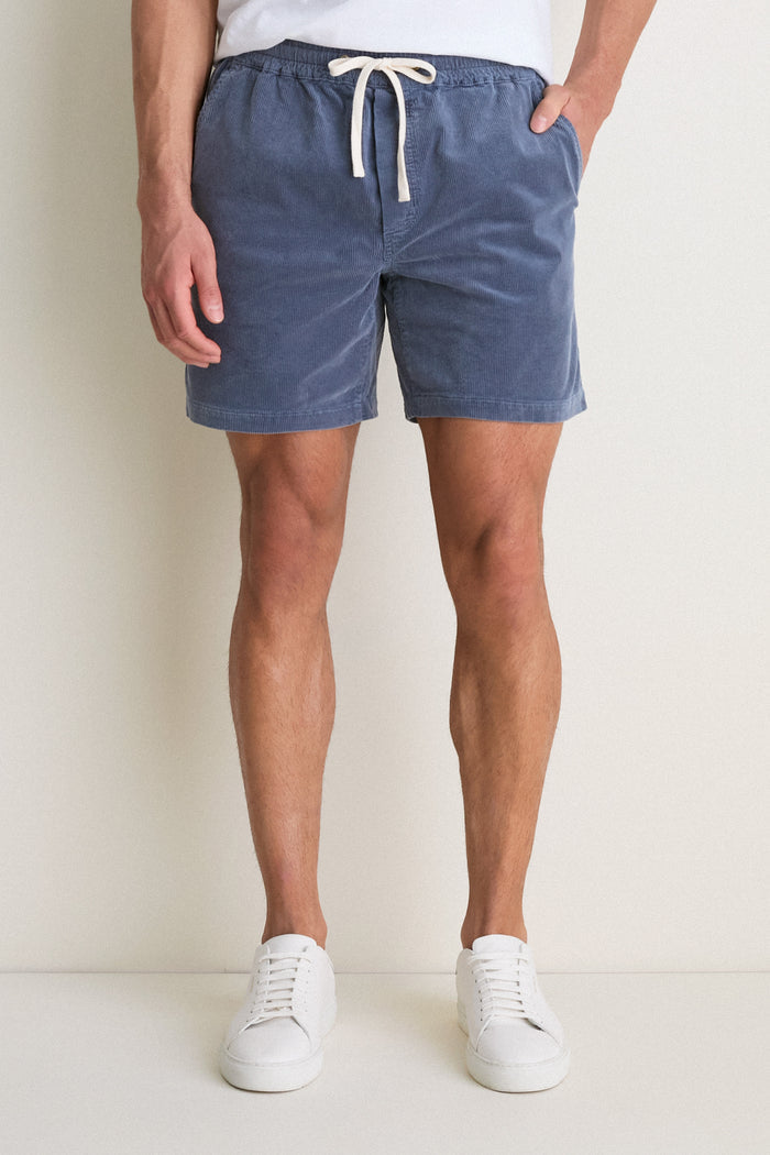 Classic and effortless, Marine Layer's Faded Navy Saturday Corduroy Short features a white drawstring, side pockets, and a hidden zipper phone pocket for a high-end, fun summer look.