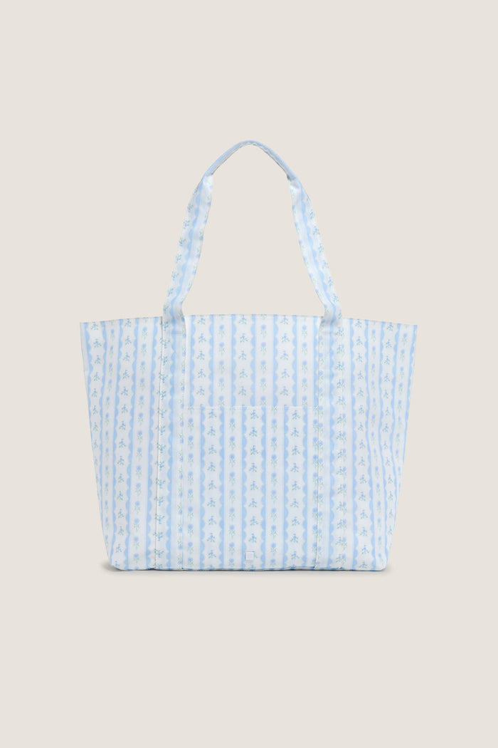 Floral Blue Ribbon Jumbo Tote features classic blue-and-white stripes with floral motifs, offering an effortless, high-end touch to your fun, everyday carry-all needs.