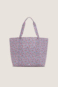 Garden Floral Jumbo Tote with a ditsy floral pattern, featuring an exterior pocket and sturdy handles, embodies effortless, classic style perfect for a fun, high-end shopping experience.