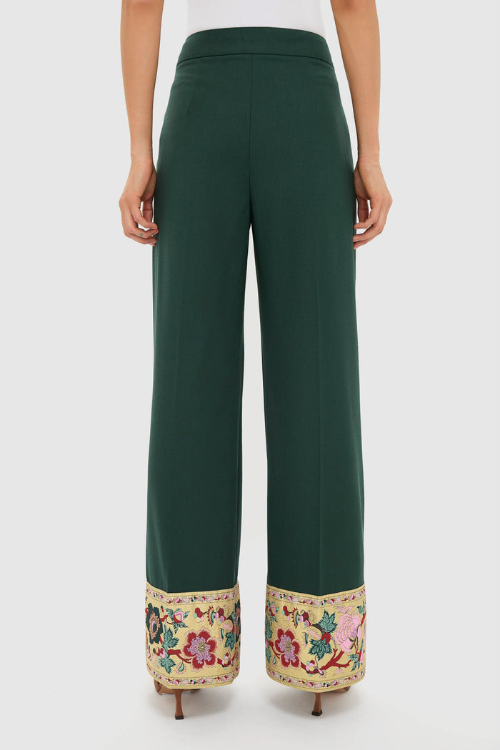 Woman wearing Garden Scrollwork Jacquard Cuff Erin Pants, showcasing classic high-waisted, wide-leg trousers with an effortless embroidered cuff detail, styled with a white top and heels.