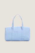 Gingham Sky Weekender Duffel Bag in light blue gingham pattern, featuring a classic, effortless design with dual handles and a playful, high-end feel.