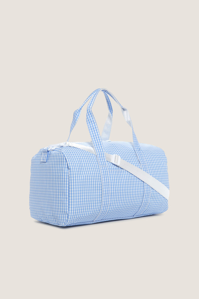 Gingham Sky Weekender Duffel Bag: A classic, effortless travel bag with playful gingham print, detachable strap, water-resistant finish, and spacious interior for fun, high-end escapes.