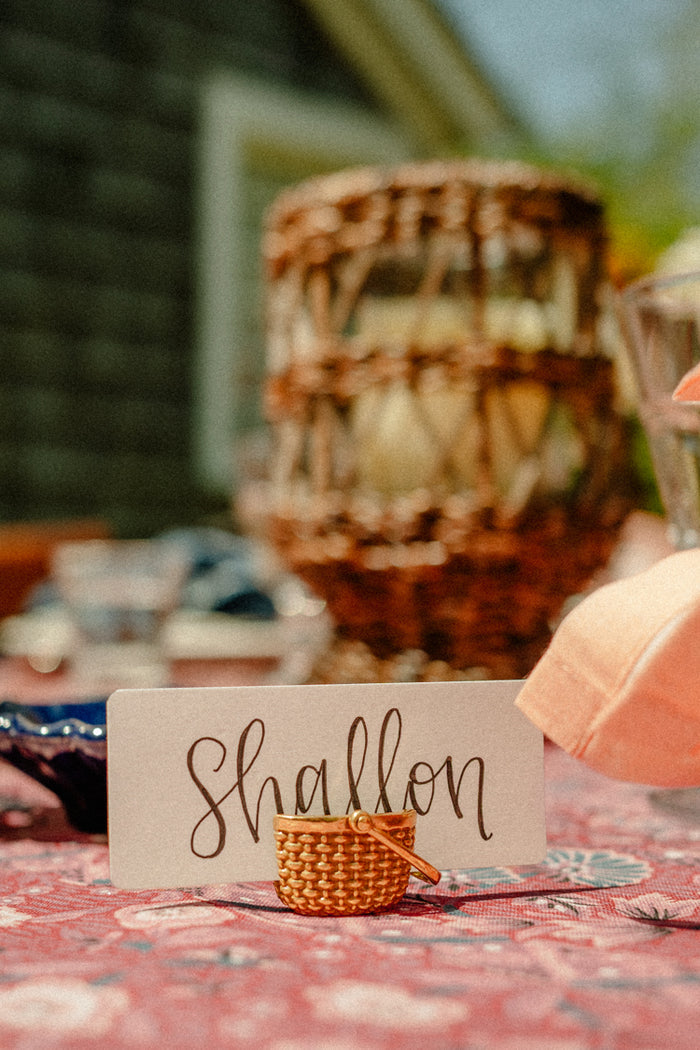 A place card that says "shallon" and a basket place card holder.
